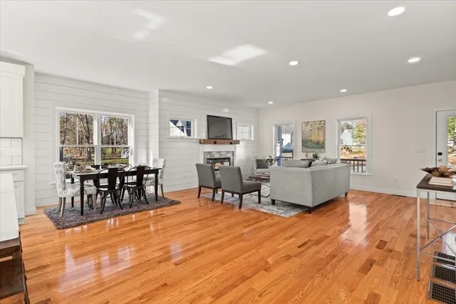 a living room with furniture wooden floor and a view of kitchen