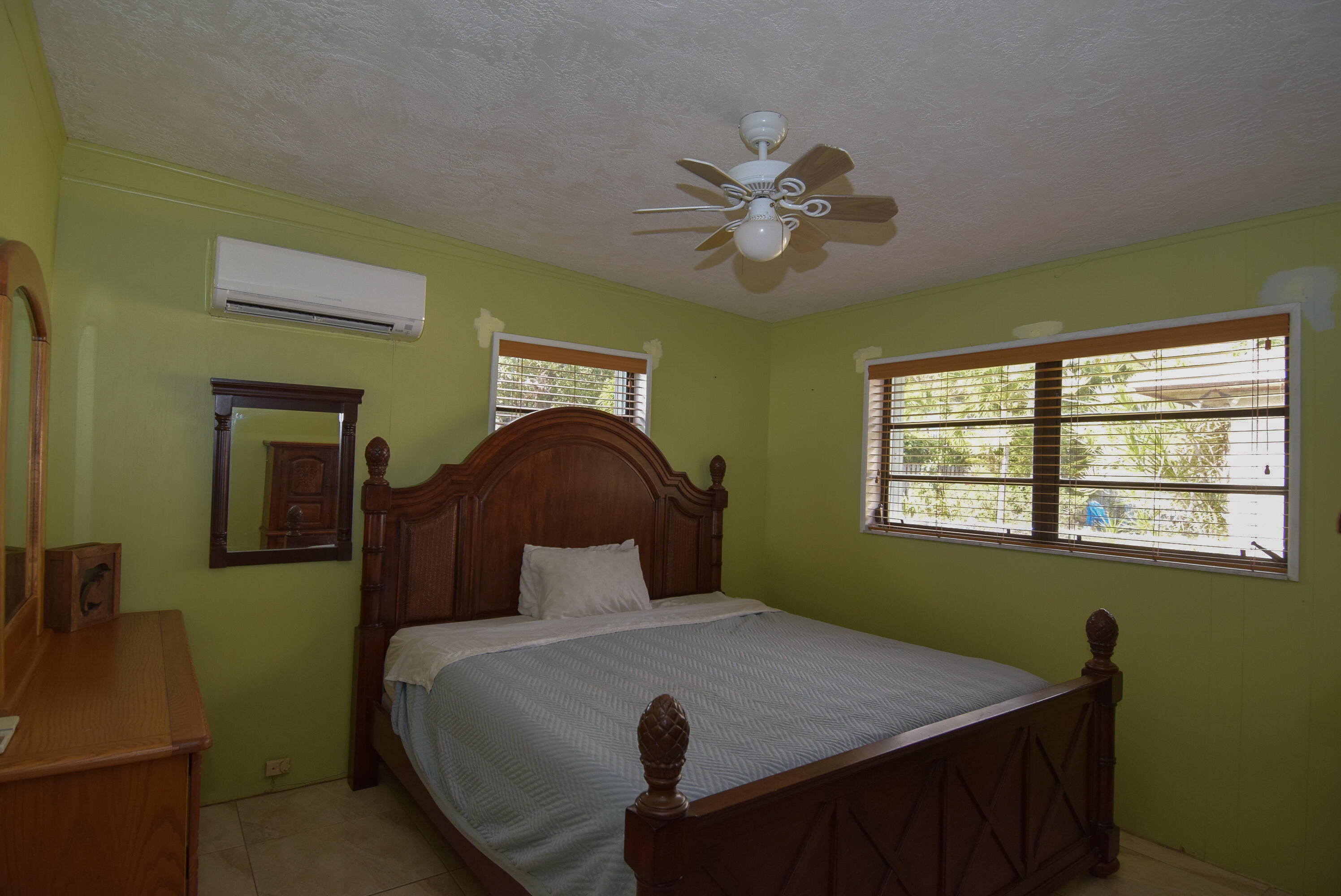 237 2nd Road Key Largo, FL 33037 - Photo 14 of 25 a bedroom with a bed and a chandelier
