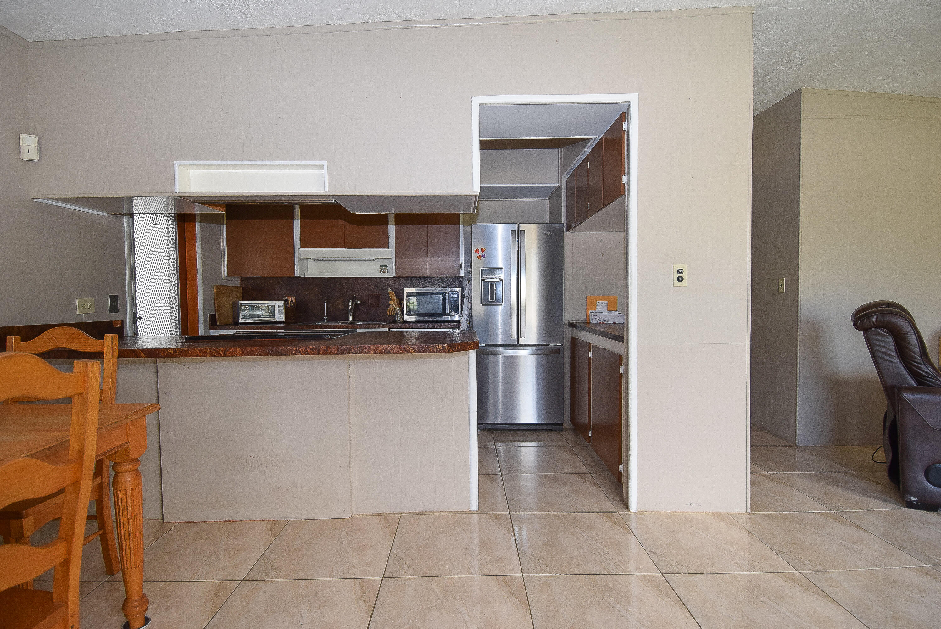 237 2nd Road Key Largo, FL 33037 - Photo 3 of 25 a kitchen with stainless steel appliances granite countertop a refrigerator and a stove