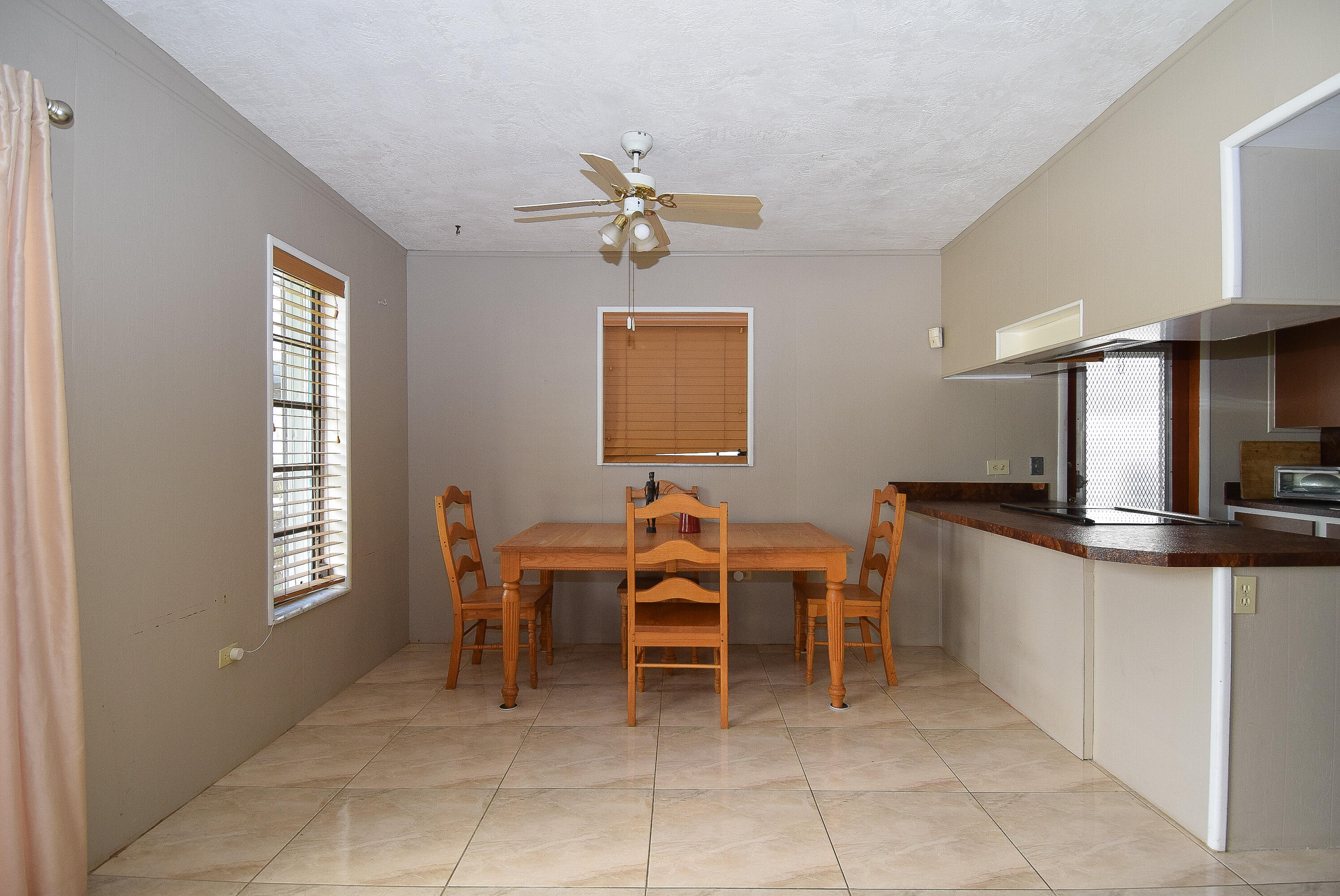 237 2nd Road Key Largo, FL 33037 - Photo 5 of 25 a dining room with a window and chairs