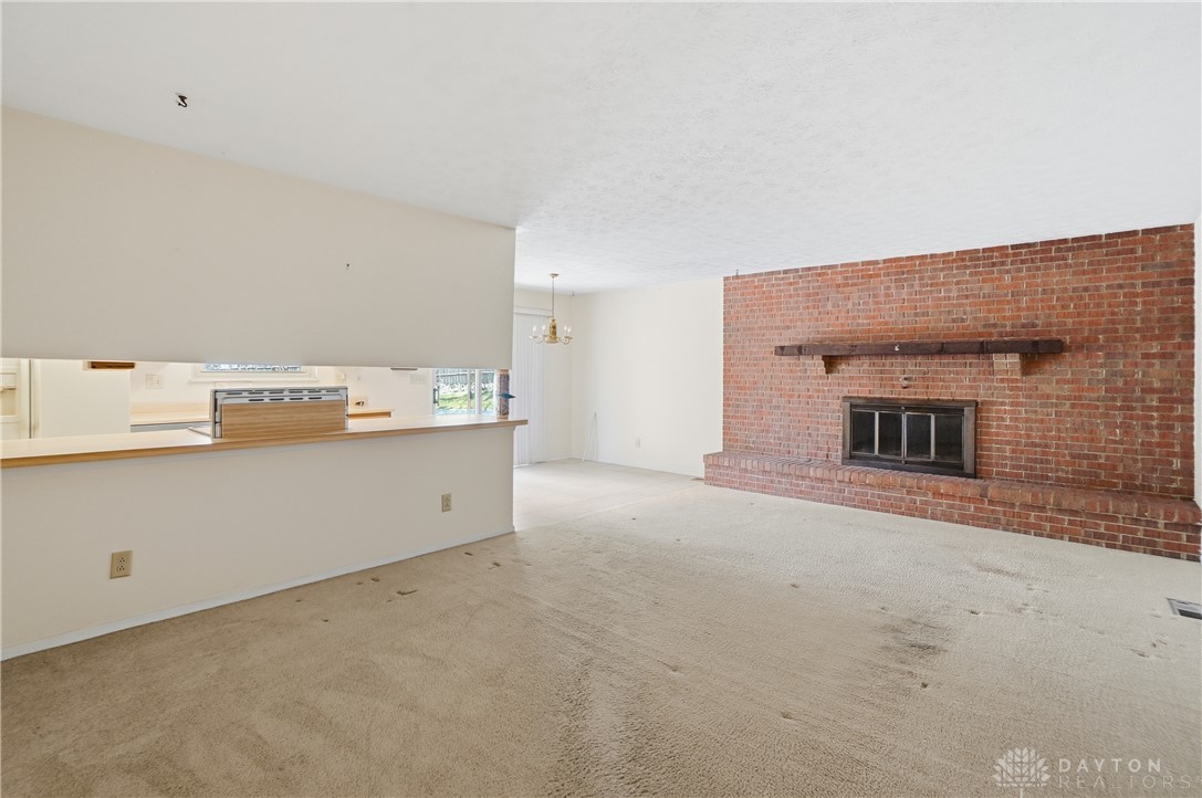 9964 Hummingbird Way Dayton, OH 45458 - Photo 25 of 57 This inviting living space features an impressive brick fireplace and an open concept layout.
