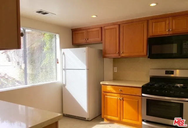 a kitchen with a refrigerator stove and microwave