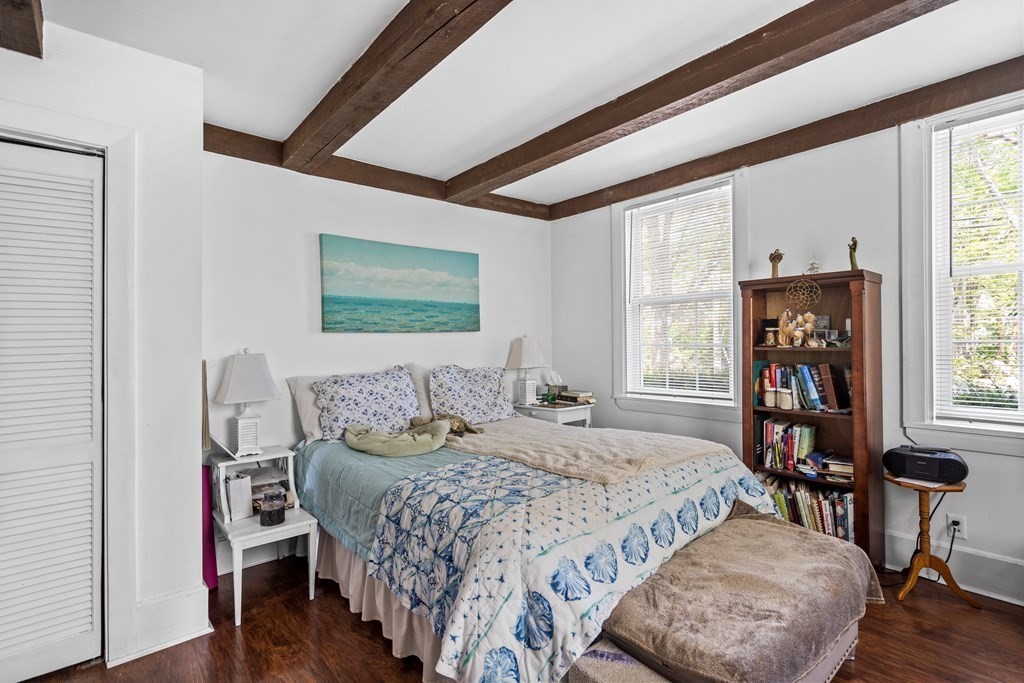 44 Stockbridge Road Scituate, MA 02066 - Photo 5 of 24 a bedroom with a bed a table and a large window