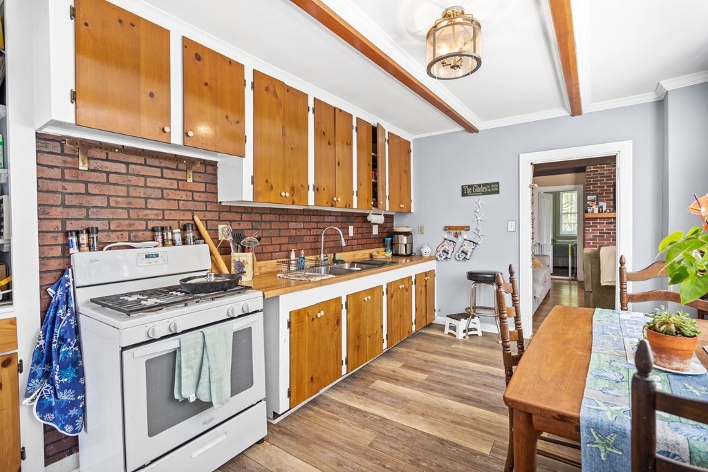 44 Stockbridge Road Scituate, MA 02066 - Photo 7 of 24 a kitchen with stainless steel appliances granite countertop a stove and a sink
