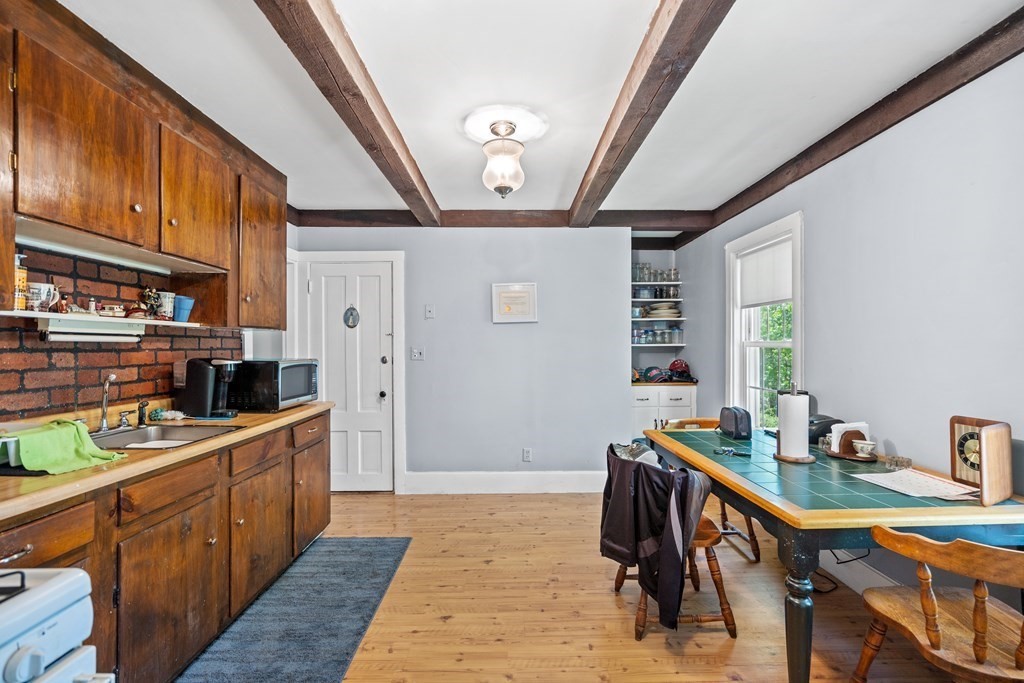 44 Stockbridge Road Scituate, MA 02066 - Photo 10 of 24 a kitchen with stainless steel appliances granite countertop a sink refrigerator and cabinets