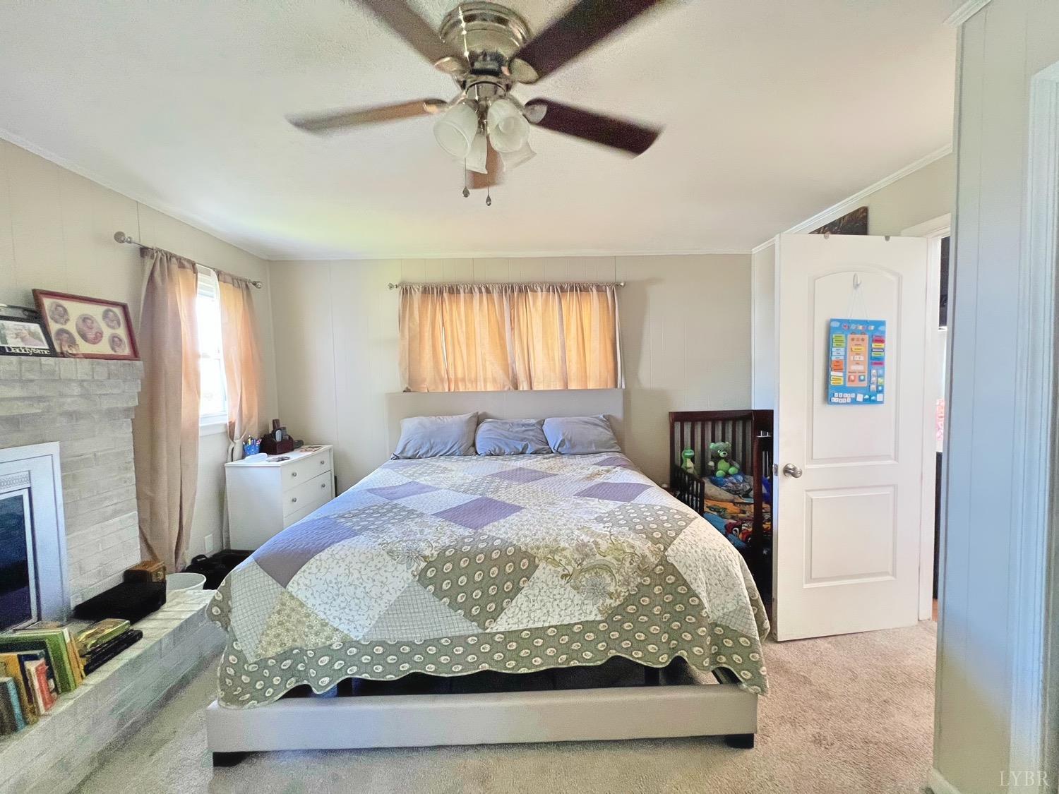 2517 Moons Road Long Island, VA 24569 - Photo 8 of 18 a bedroom with a bed and a fireplace