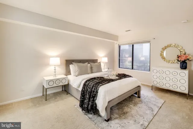 a bedroom with a bed and a night stand