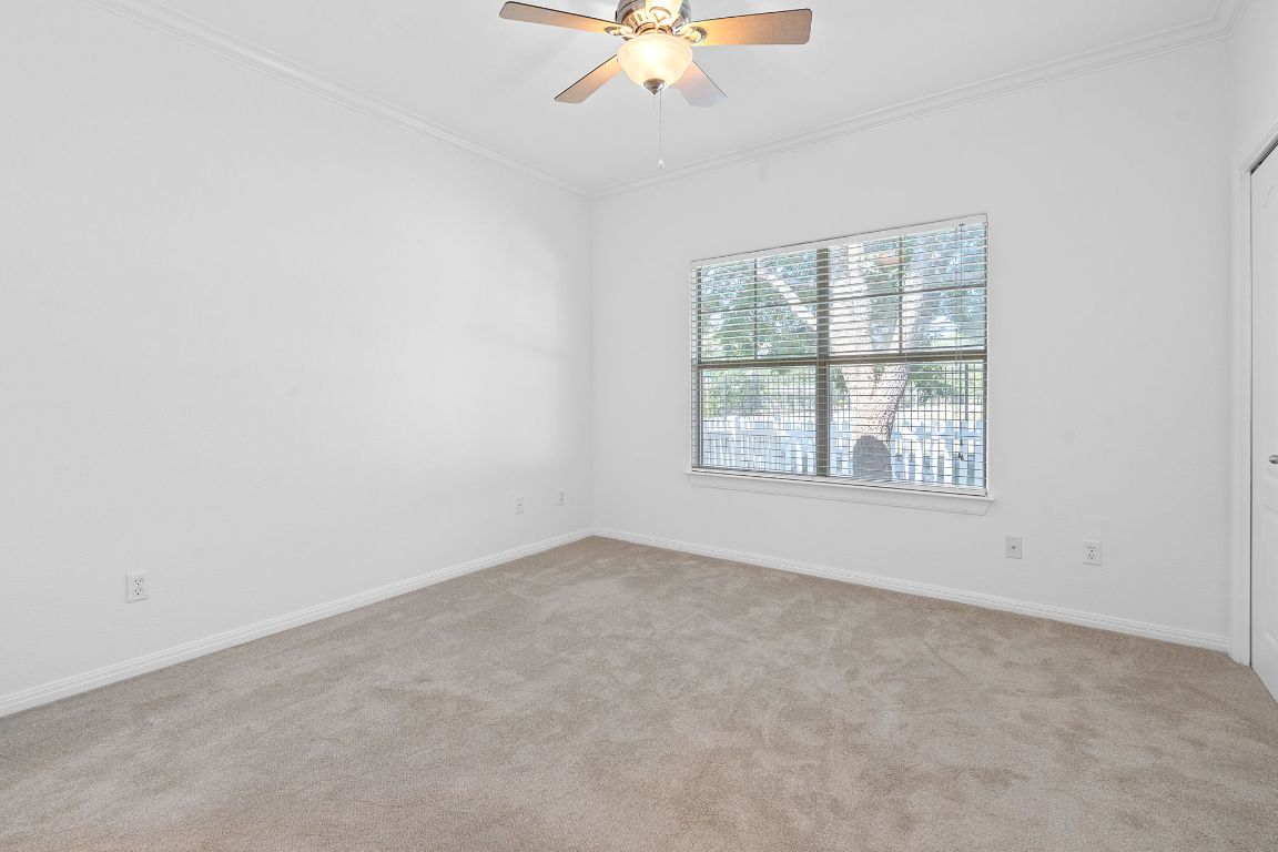 6801 Beckett Road, Unit 119R Austin, TX 78749 - Photo 12 of 26 an empty room with a window and a ceiling fan