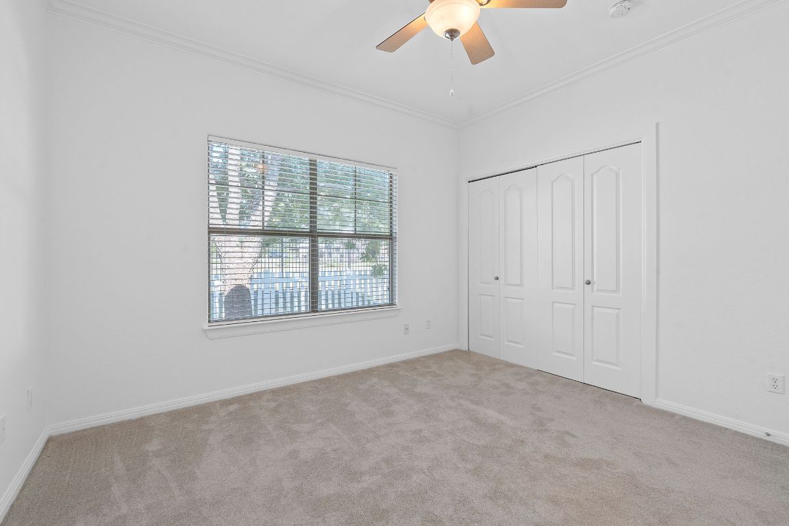6801 Beckett Road, Unit 119R Austin, TX 78749 - Photo 13 of 26 an empty room with chandelier fan