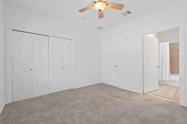 an empty room with chandelier fan