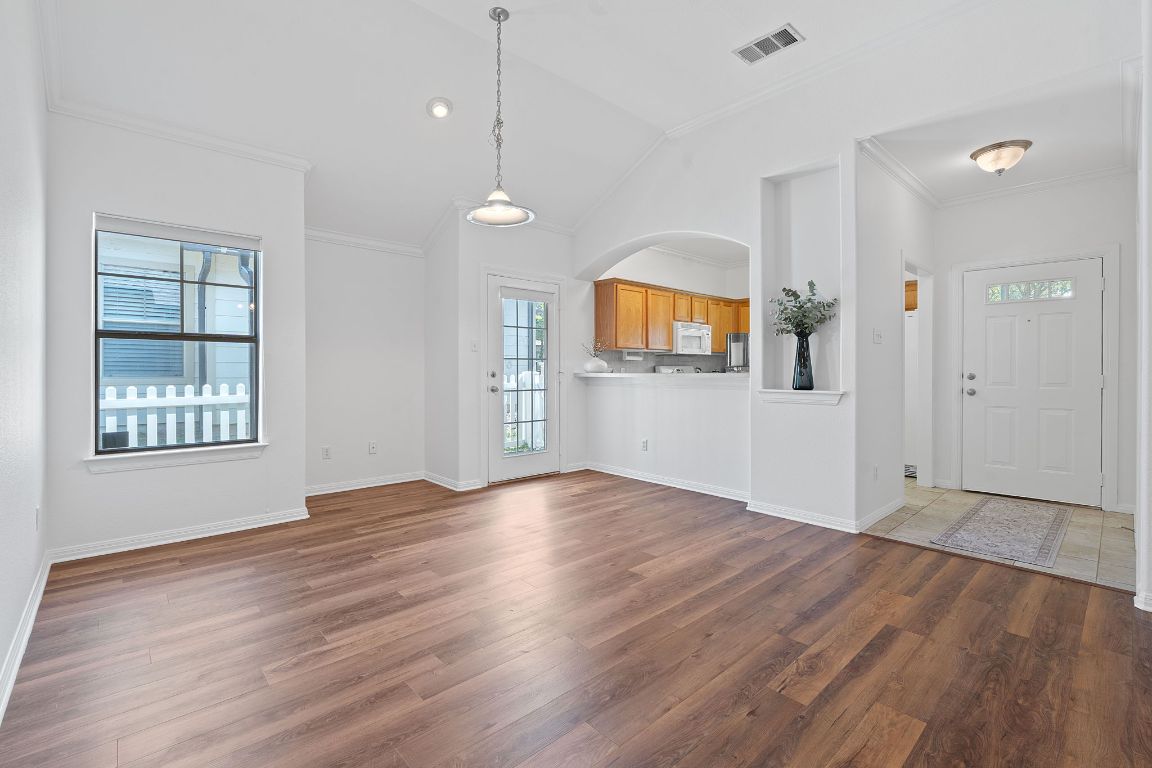 6801 Beckett Road, Unit 119R Austin, TX 78749 - Photo 3 of 26 an empty room with wooden floor and windows