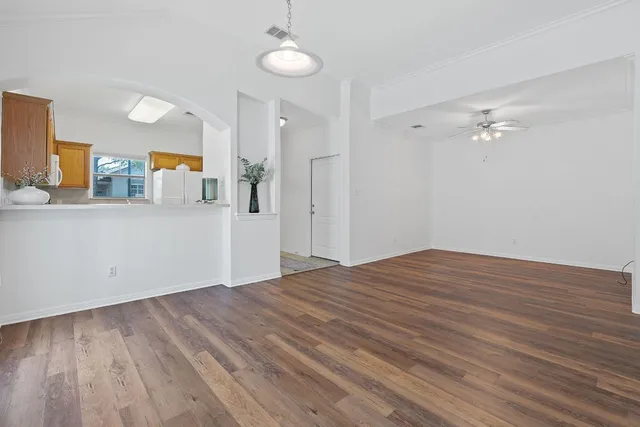 a view of a kitchen with wooden floor and a sink