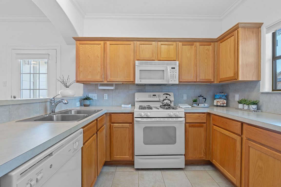 6801 Beckett Road, Unit 119R Austin, TX 78749 - Photo 8 of 26 a kitchen with stainless steel appliances granite countertop a sink and cabinets