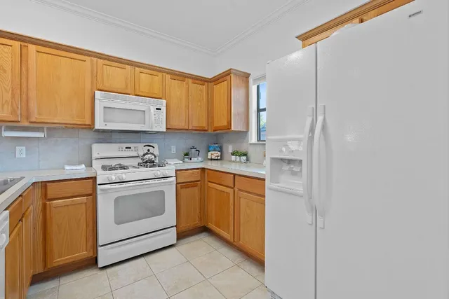 a kitchen with stainless steel appliances granite countertop a sink and a refrigerator