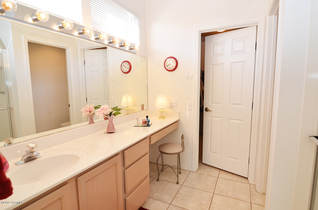 1330 East Crown Ridge Drive Tucson, AZ 85755 - Photo 12 of 22 a bathroom with a sink vanity and a mirror