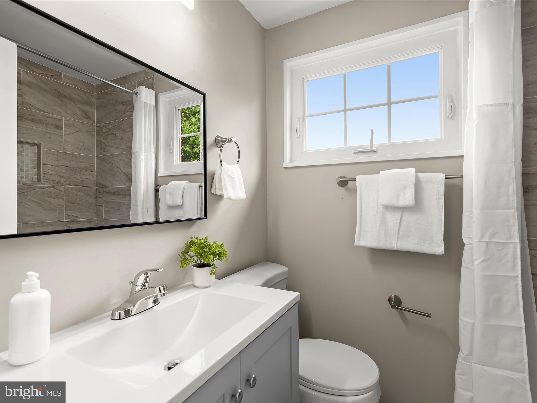 13214 Holdridge Road Silver Spring, MD 20906 - Photo 17 of 33 a bathroom with a sink vanity mirror and toilet