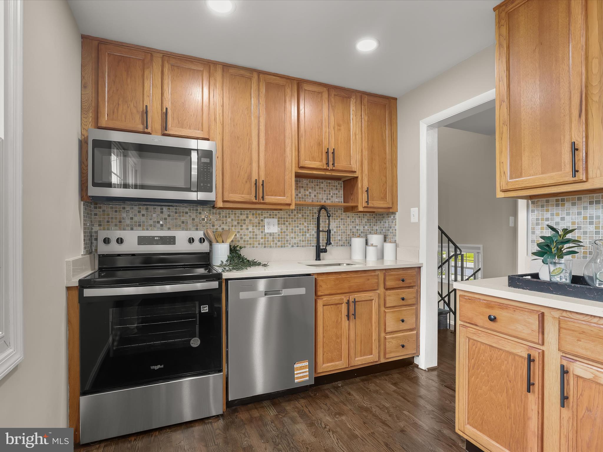13214 Holdridge Road Silver Spring, MD 20906 - Photo 4 of 33 a kitchen with granite countertop wooden cabinets and stainless steel appliances