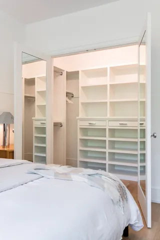 a bedroom with a bed and a walk in closet