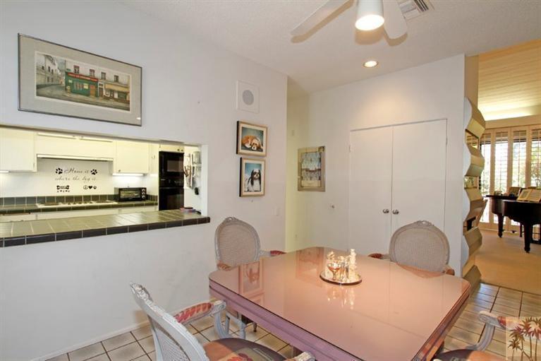 925 Inverness Drive Rancho Mirage, CA 92270 - Photo 14 of 35 a kitchen with granite countertop a table and chairs in it