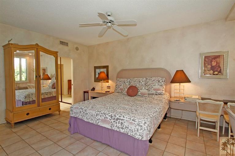 925 Inverness Drive Rancho Mirage, CA 92270 - Photo 17 of 35 a bedroom with a bed and dresser with mirror