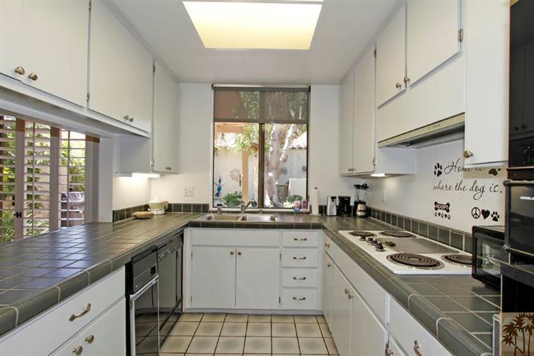 925 Inverness Drive Rancho Mirage, CA 92270 - Photo 2 of 35 a kitchen with a sink stove and cabinets