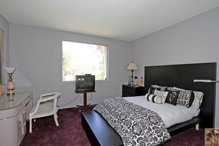 925 Inverness Drive Rancho Mirage, CA 92270 - Photo 21 of 35 a bedroom with a bed and wooden floor