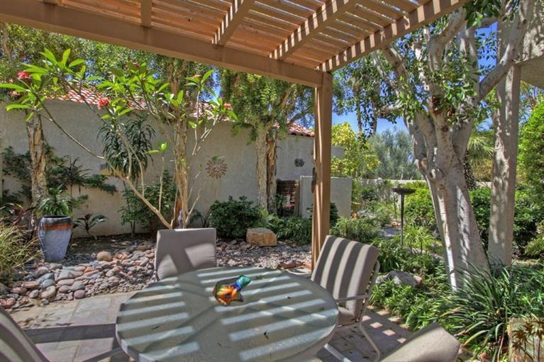 925 Inverness Drive Rancho Mirage, CA 92270 - Photo 32 of 35 a view of a patio with table and chairs potted plants and large tree