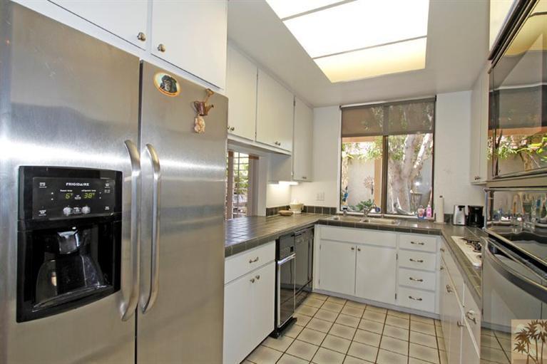 925 Inverness Drive Rancho Mirage, CA 92270 - Photo 5 of 35 a kitchen with stainless steel appliances granite countertop a refrigerator and a sink