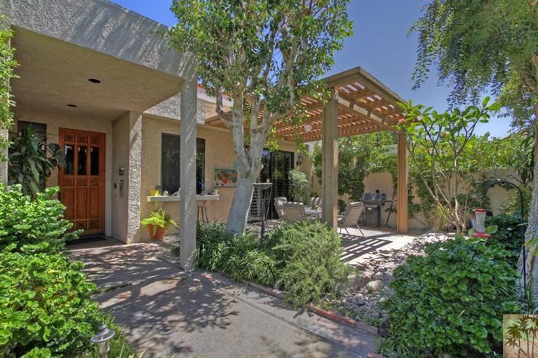 925 Inverness Drive Rancho Mirage, CA 92270 - Photo 7 of 35 a view of a house with a small yard plants and large tree