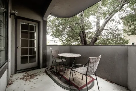 a view of a chairs and table in the patio