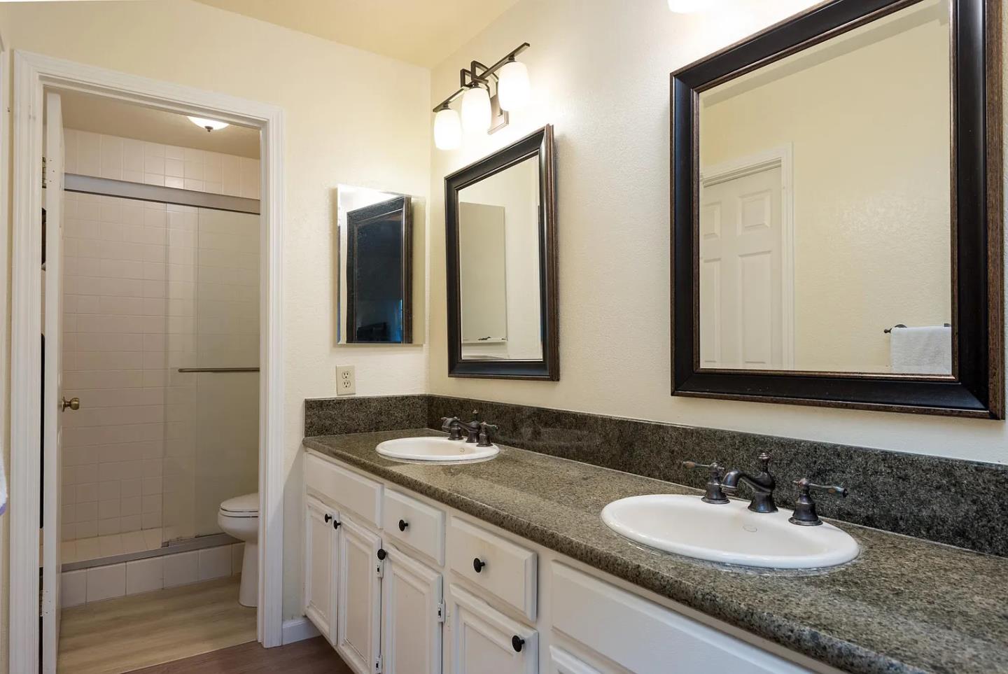 112 Madison Avenue, Unit 108 San Mateo, CA 94402 - Photo 9 of 17 a bathroom with a granite countertop sink and a mirror