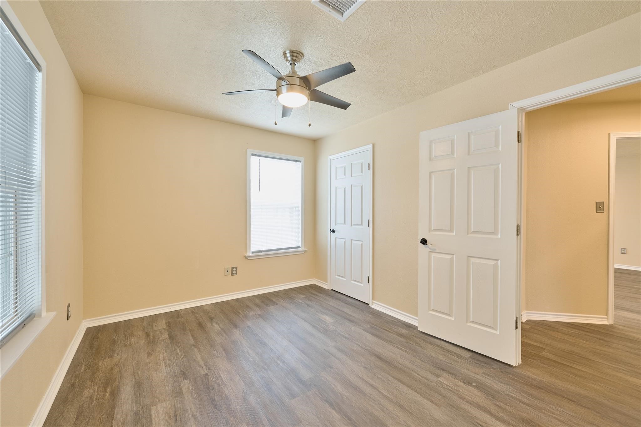 450 Ritchey Road Coldspring, TX 77331 - Photo 17 of 27 wooden floor in an empty room with a window