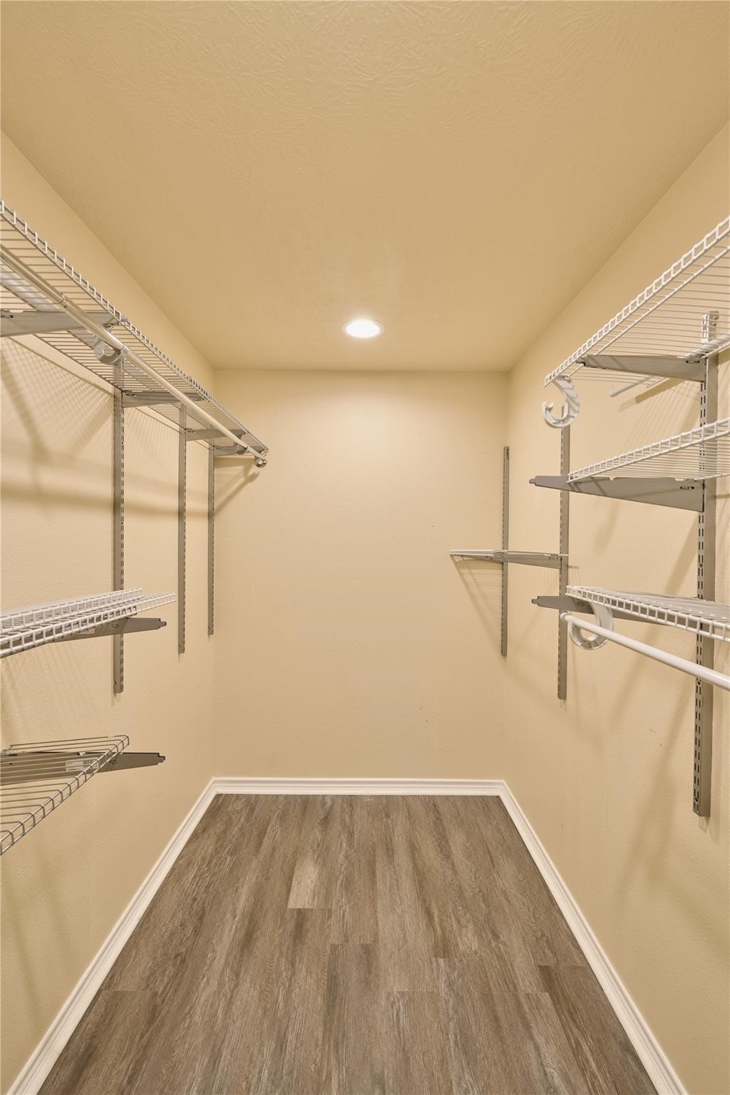 450 Ritchey Road Coldspring, TX 77331 - Photo 18 of 27 a view of an empty room with wooden floor and a window