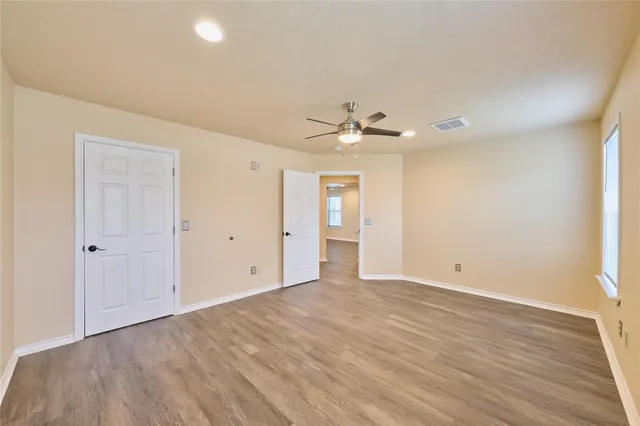 a view of an empty room with wooden floor