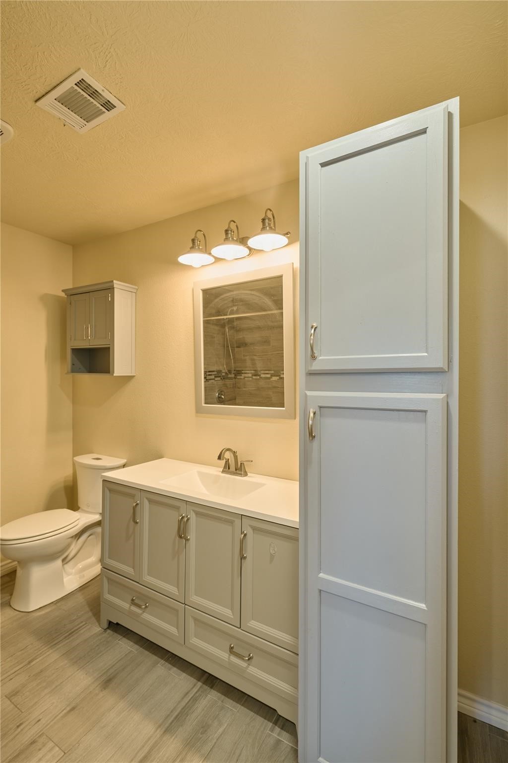 450 Ritchey Road Coldspring, TX 77331 - Photo 20 of 27 a bathroom with a toilet sink and mirror