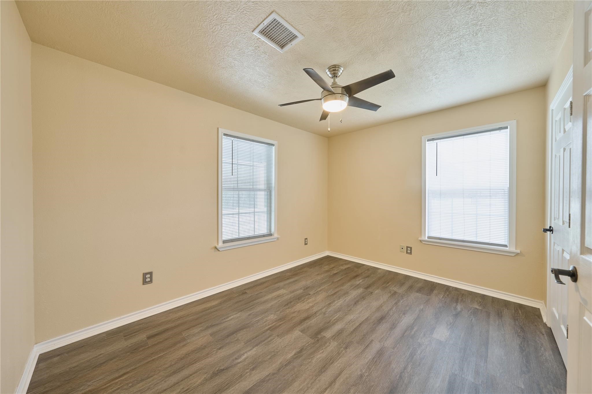 450 Ritchey Road Coldspring, TX 77331 - Photo 22 of 27 a view of an empty room with a window and wooden floor