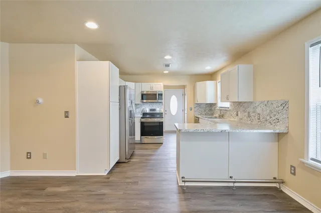 a kitchen with a refrigerator and a sink