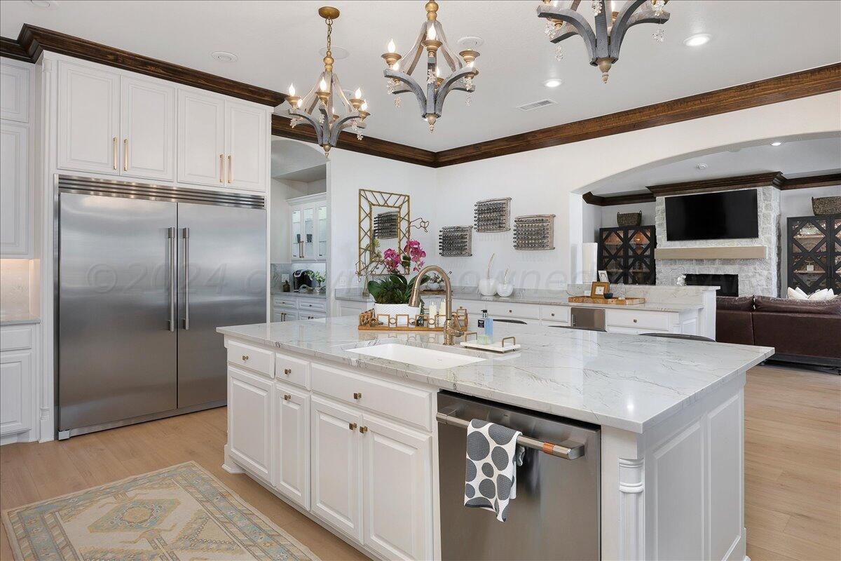 17701 White Wing Road Canyon, TX 79015 - Photo 18 of 76 a kitchen with stainless steel appliances a sink stove and refrigerator