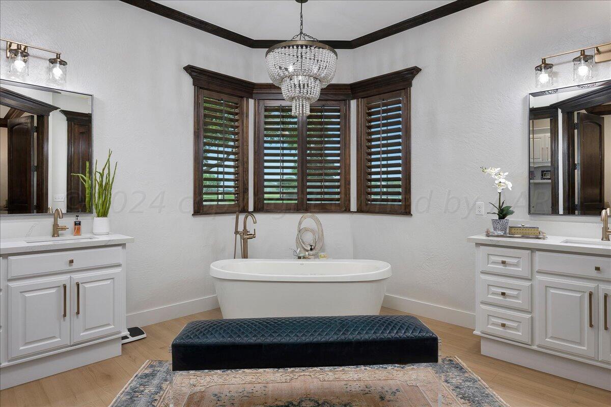 17701 White Wing Road Canyon, TX 79015 - Photo 24 of 76 a bathroom with a sink a mirror and a bathtub