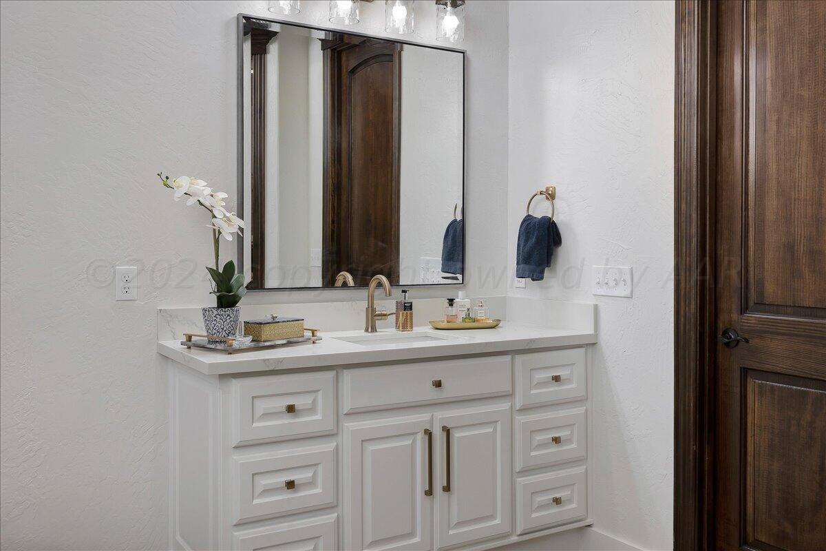 17701 White Wing Road Canyon, TX 79015 - Photo 26 of 76 a bathroom with a double vanity sink and mirror