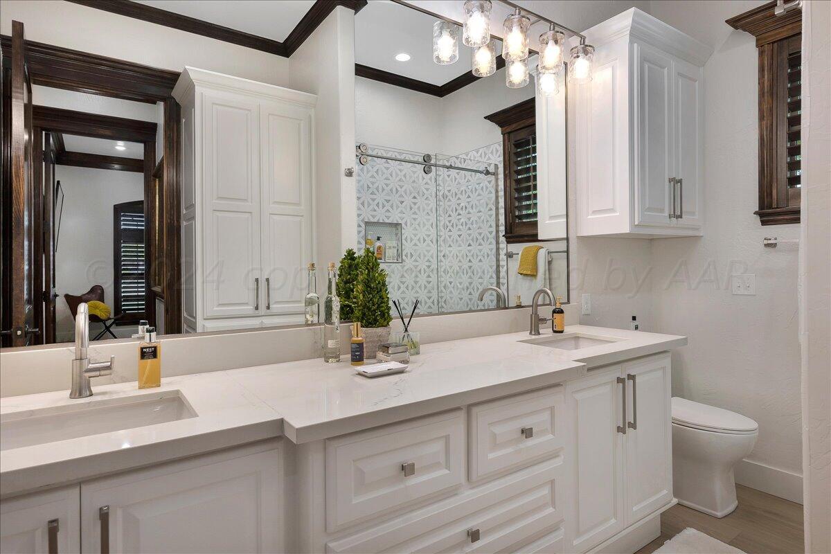 17701 White Wing Road Canyon, TX 79015 - Photo 28 of 76 a bathroom with a sink double vanity and a mirror
