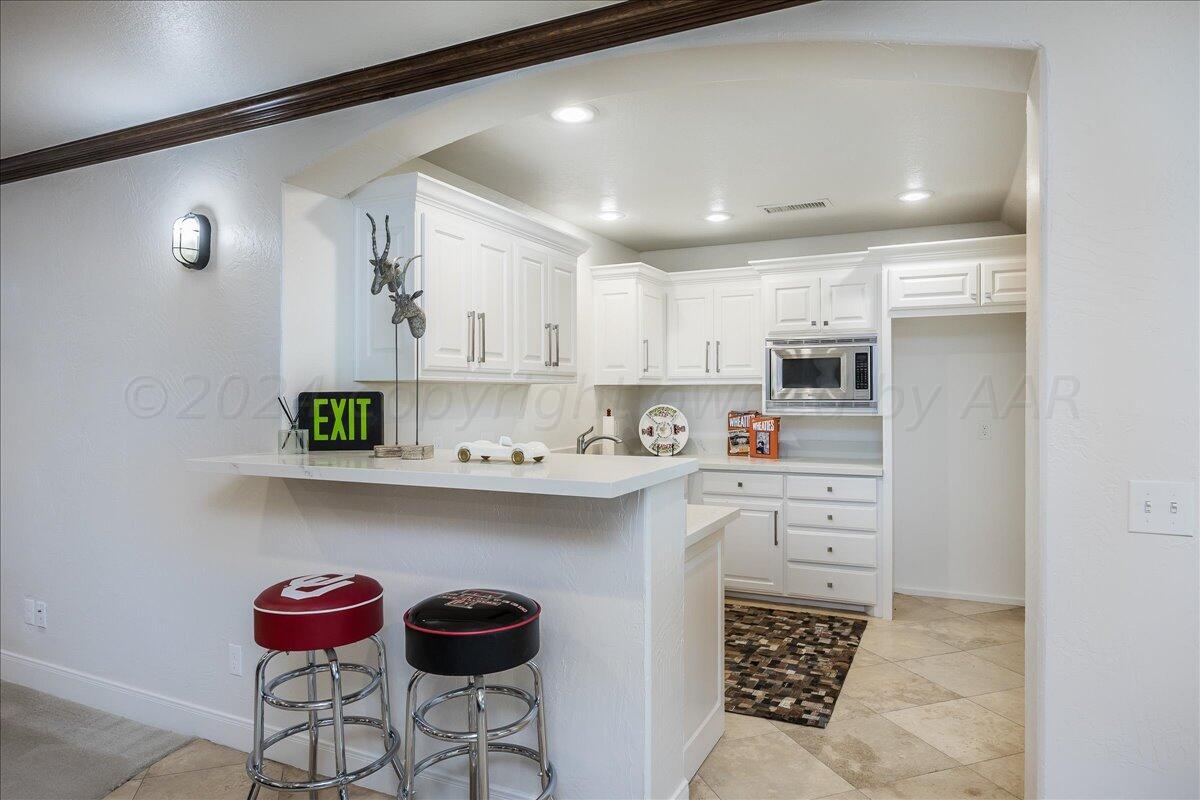 17701 White Wing Road Canyon, TX 79015 - Photo 33 of 76 a kitchen with stainless steel appliances granite countertop a sink and cabinets