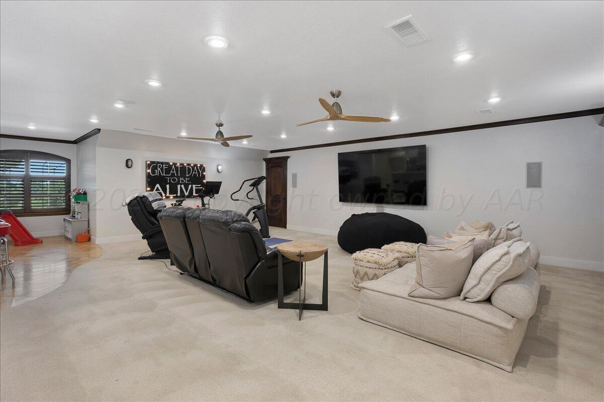 17701 White Wing Road Canyon, TX 79015 - Photo 35 of 76 a living room with furniture and a flat screen tv