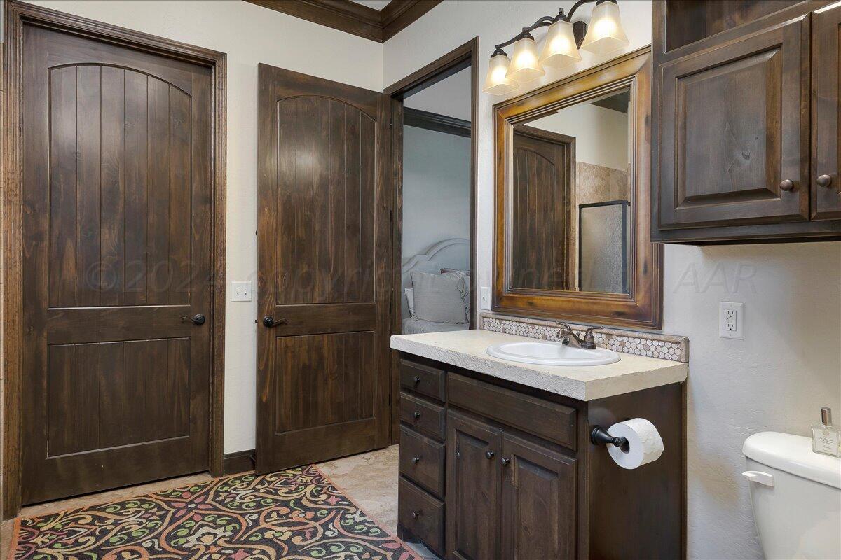 17701 White Wing Road Canyon, TX 79015 - Photo 47 of 76 a bathroom with a sink a toilet and shower