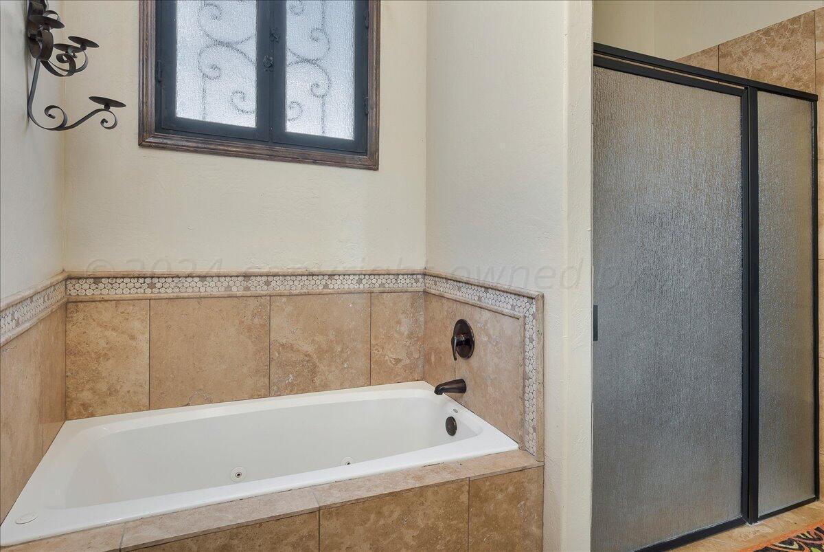 17701 White Wing Road Canyon, TX 79015 - Photo 48 of 76 a bathroom with a bathtub and shower