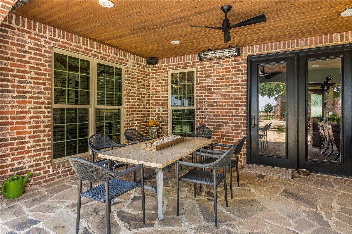 17701 White Wing Road Canyon, TX 79015 - Photo 51 of 76 a patio with table and chairs and potted plants