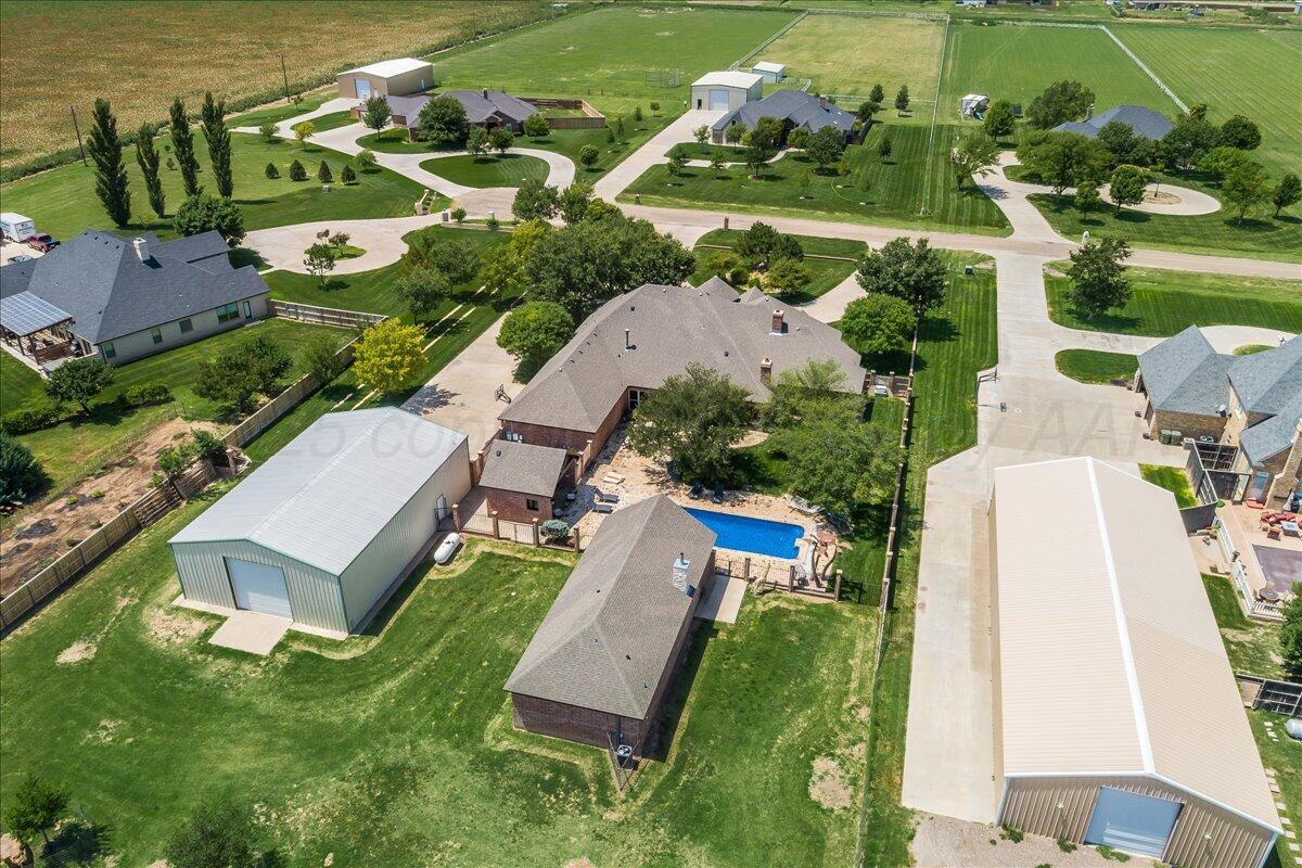 17701 White Wing Road Canyon, TX 79015 - Photo 69 of 76 an aerial view of a house with a garden and lake view