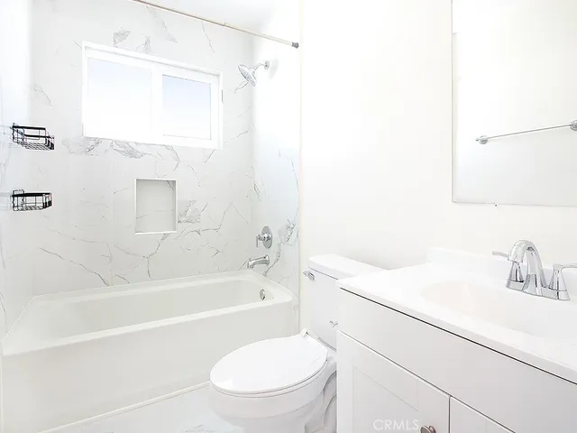 a bathroom with a sink a toilet and a bathtub