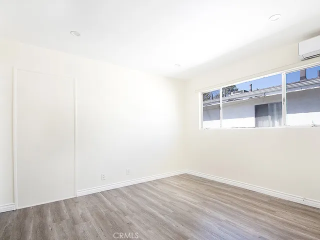 a view of a room with wooden floor and cabinet