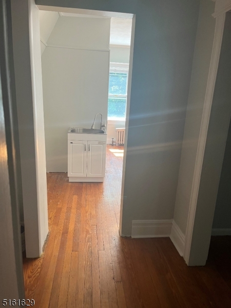 209 Hillside Avenue, Unit 2 Glen Ridge, NJ 07028 - Photo 11 of 17 an empty room with wooden floor and a window